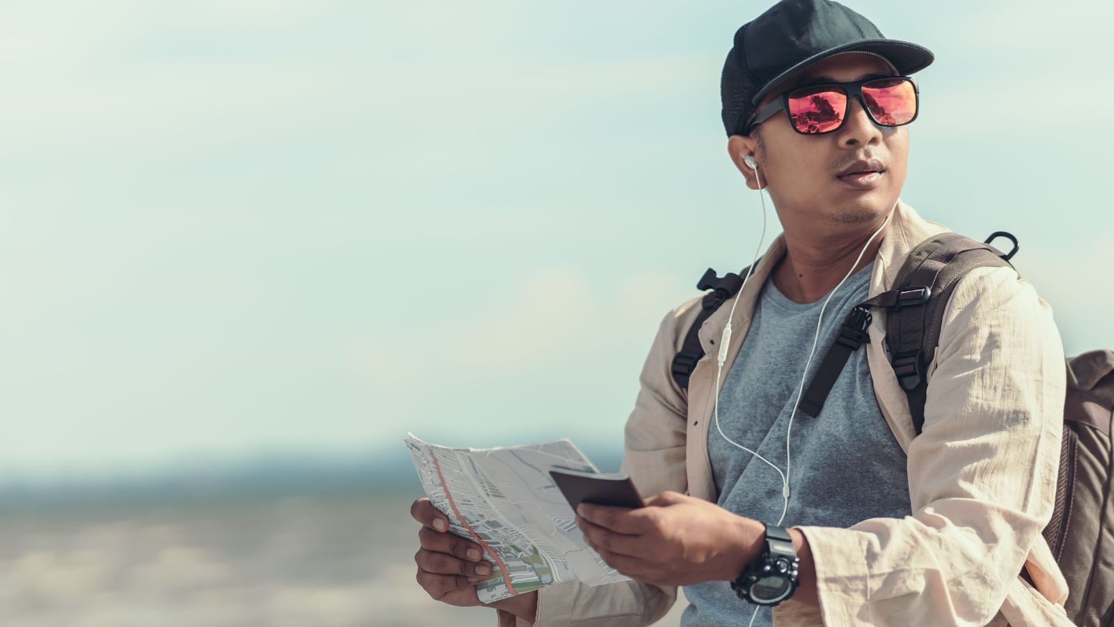 A photo of a traveler sitting in peaceful travel setting repeatedly checking phone itinerary looking slightly tense distracted.