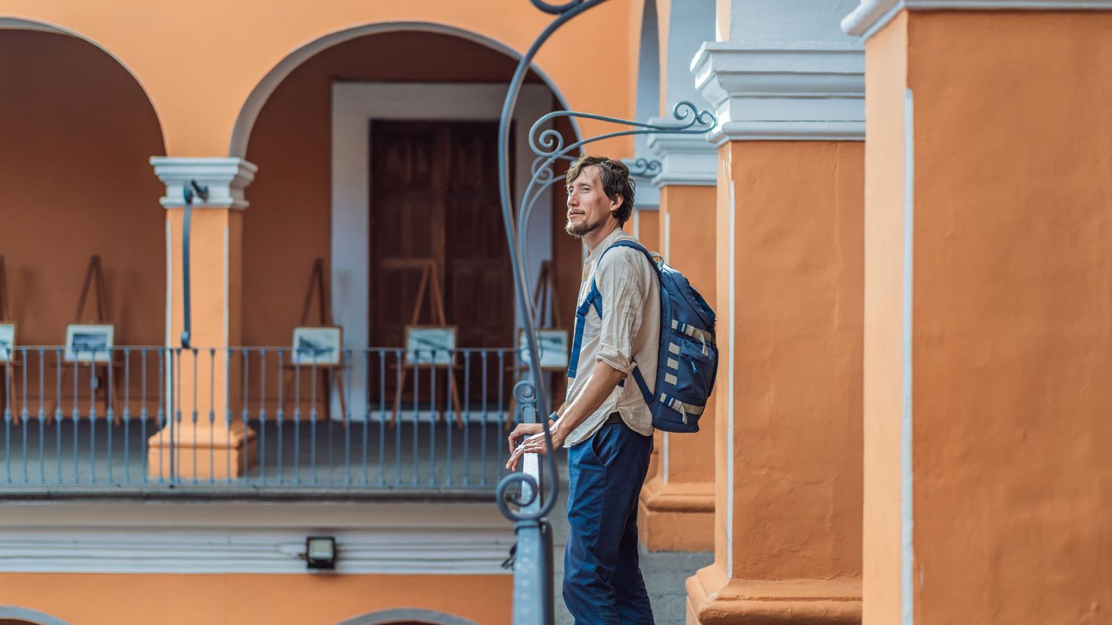 A photo of a man outside the hotel, looking around.