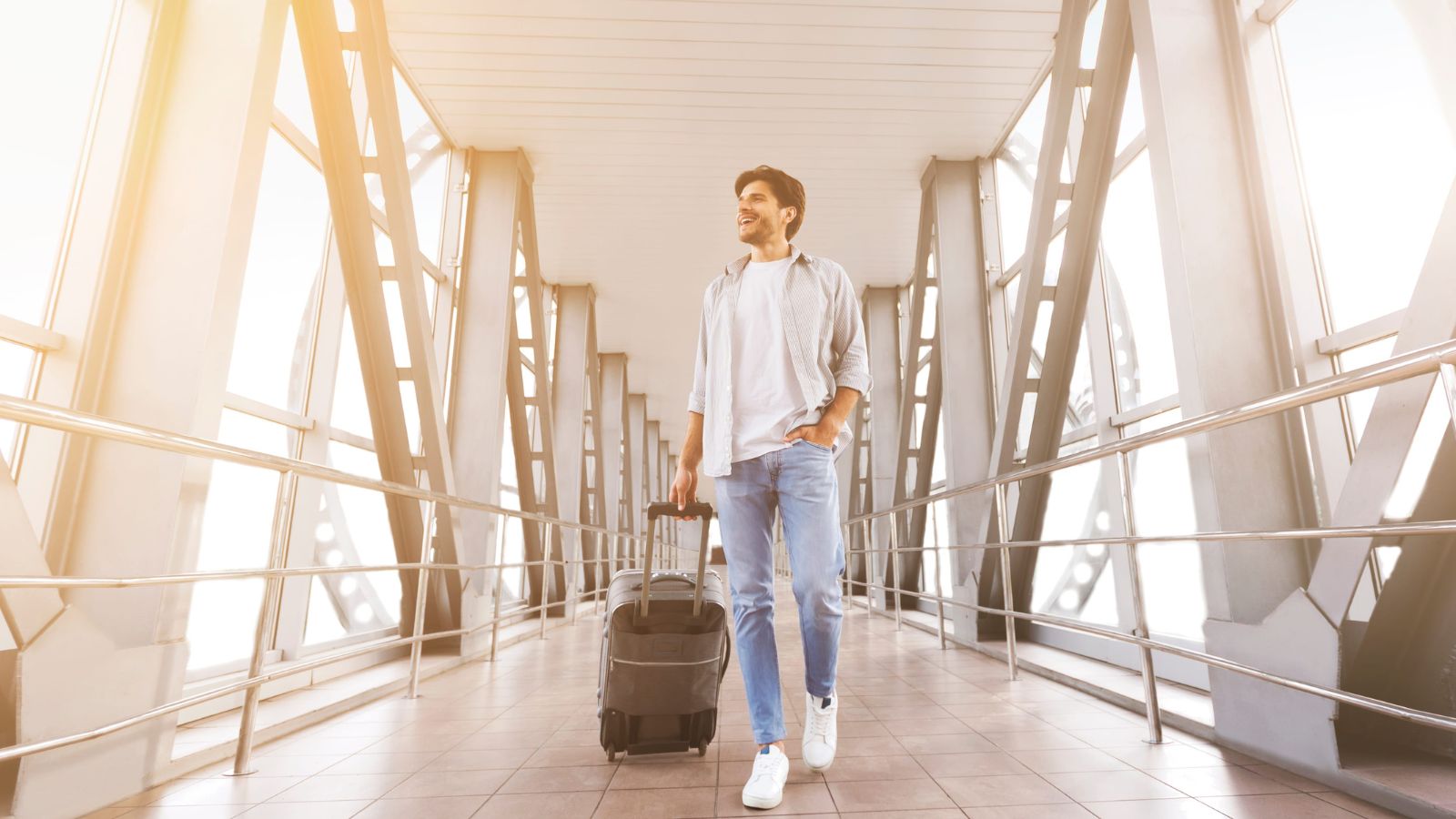 A photo of a calm traveler walking through airport with luggage unhurried relaxed travel lifestyle early arrival smooth journey candid.