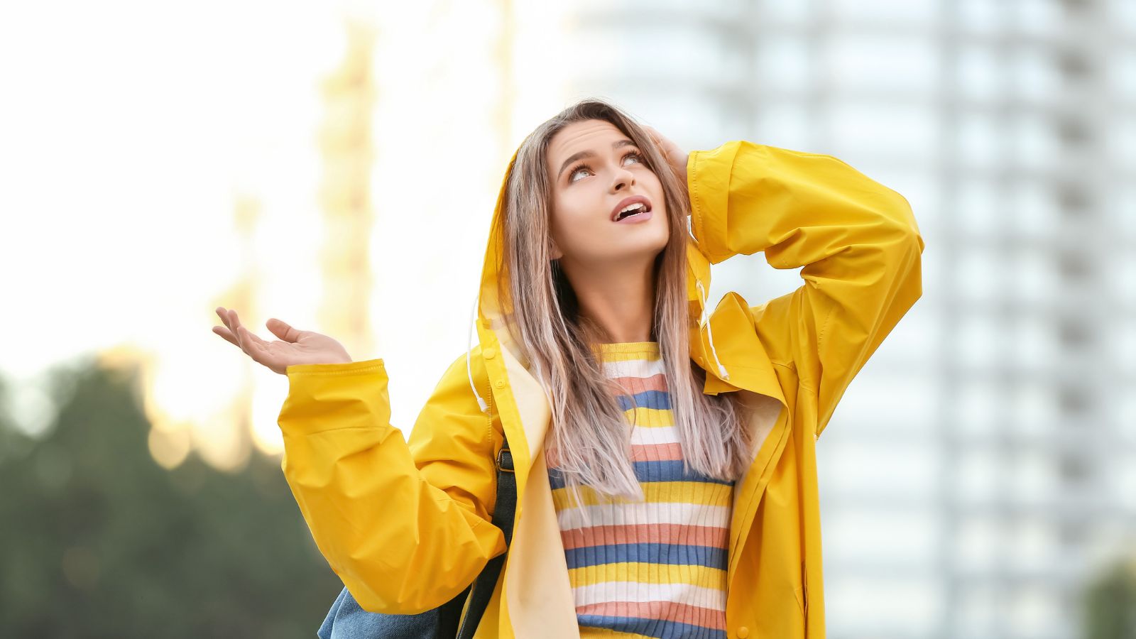 A photo of a traveler caught in light rain in a Canadian city without umbrella or rain jacket.