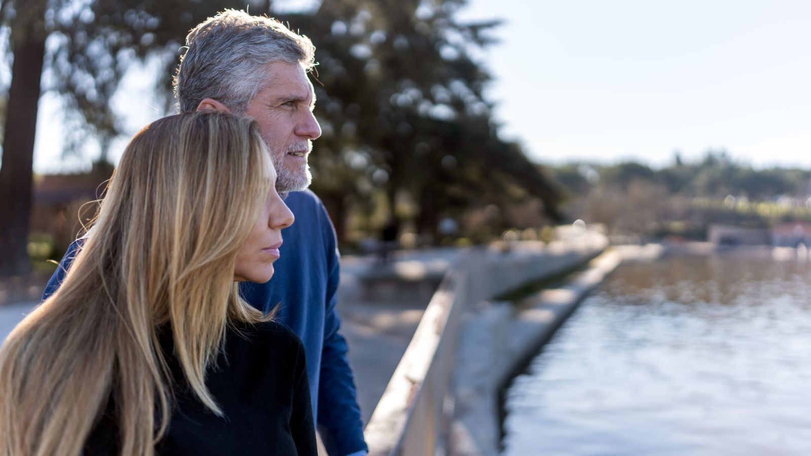 A photo of mature romantic couple arriving at peaceful destination relaxed confident travel after 50 scenic calm environment natural light candid.