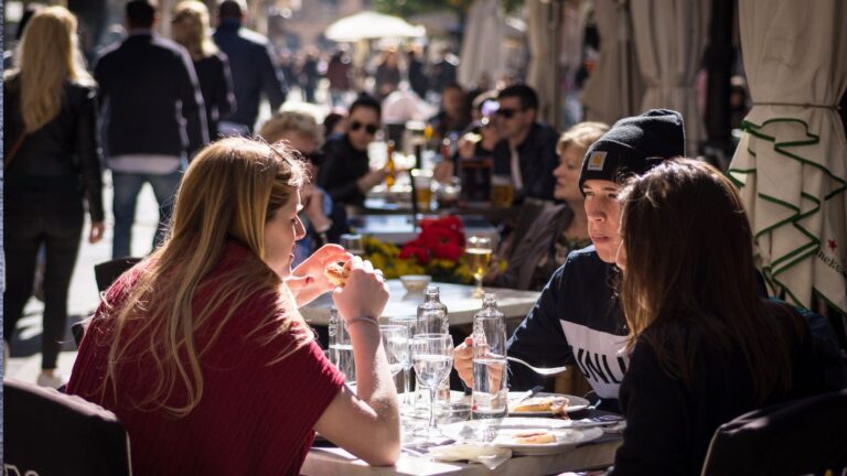 A photo of people eating outside.