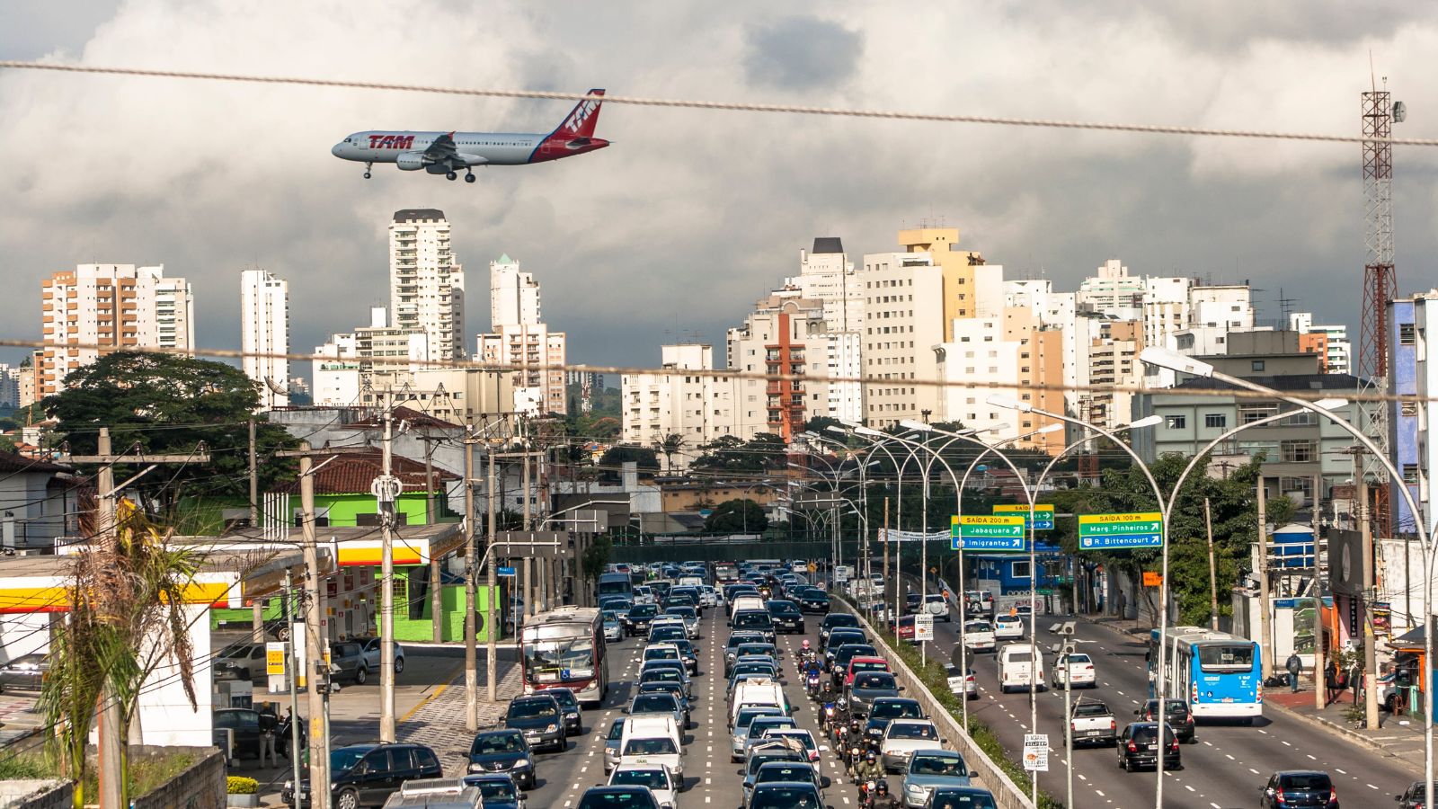 A photo of a heavy highway traffic leaving a city on the other.