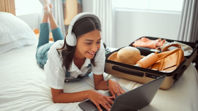 A photo of a woman resting at hotel bed.