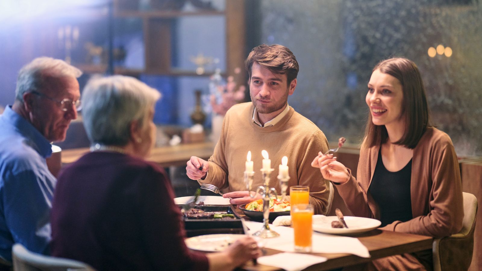 A photo of people enjoying a long relaxed dinner conversation at a European restaurant table.
