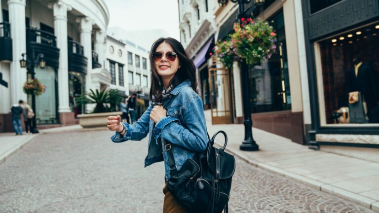 A photo of a relaxed traveler enjoying view or walking leisurely city street natural light slow travel peaceful candid.