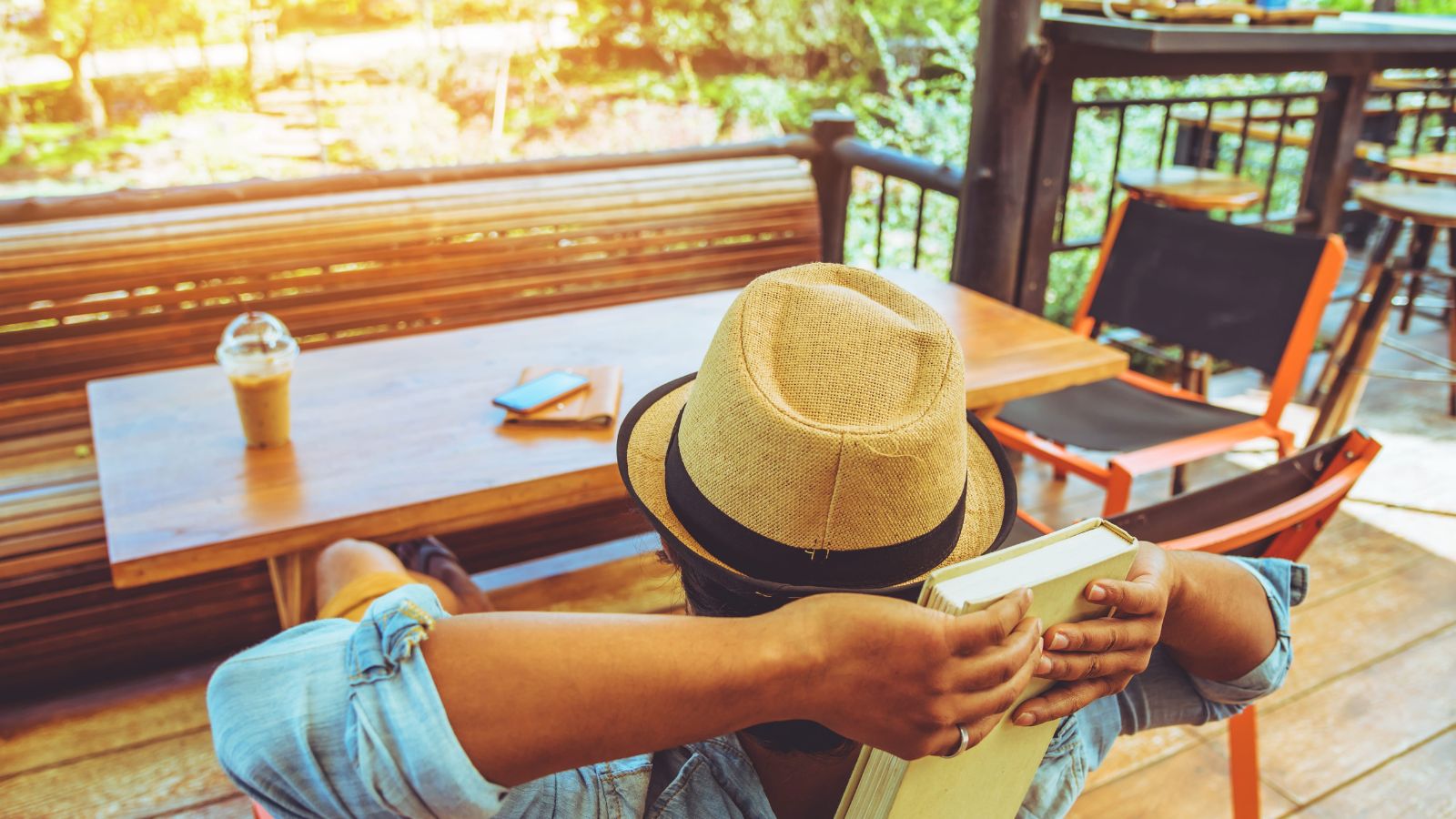 A photo of tourist walking fast in city checking watch or phone stressed tired travel busy schedule candid.