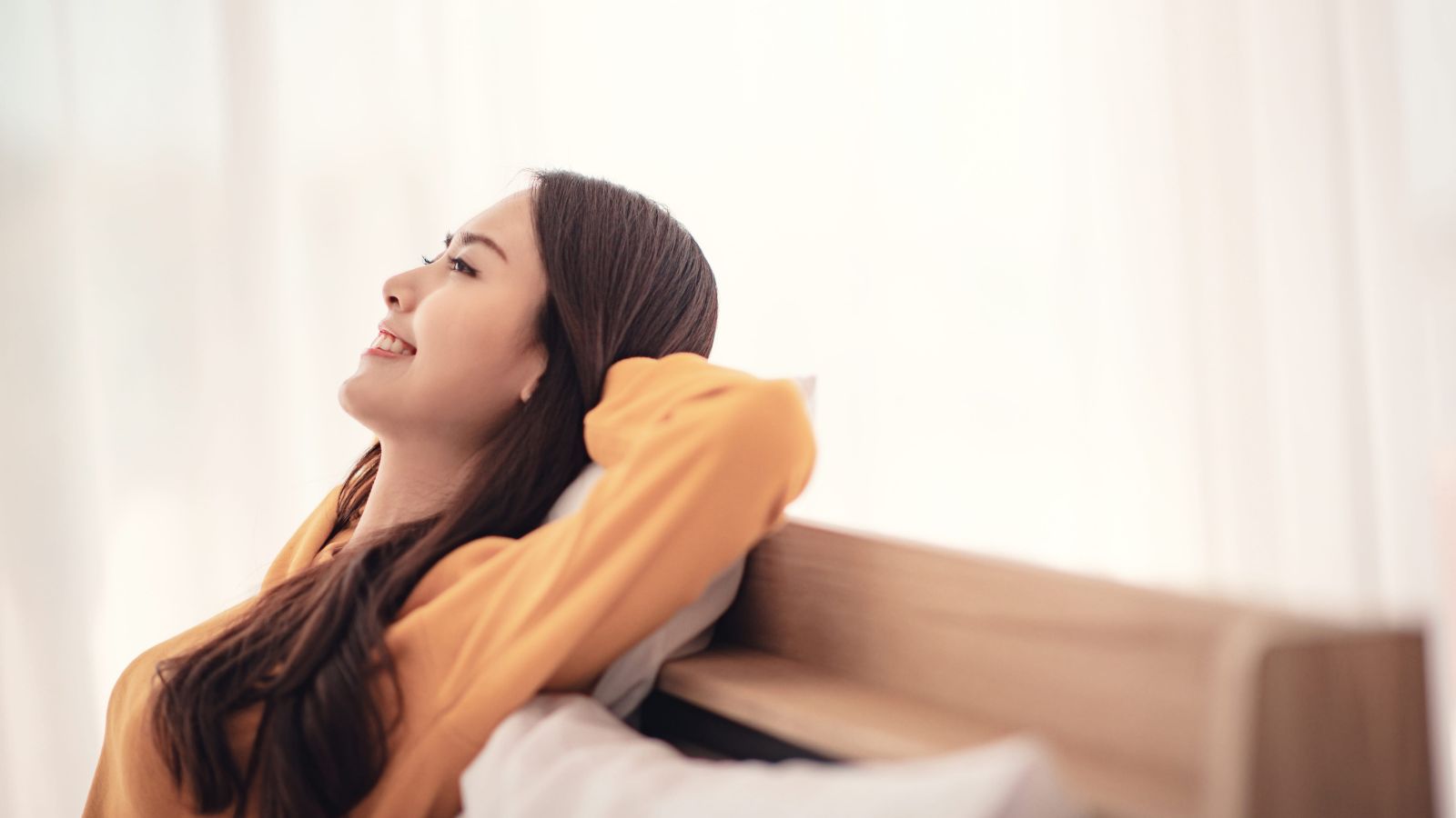 A photo of traveler relaxing comfortably in quiet well-designed hotel room peaceful atmosphere cozy interior calm satisfied travel experience.