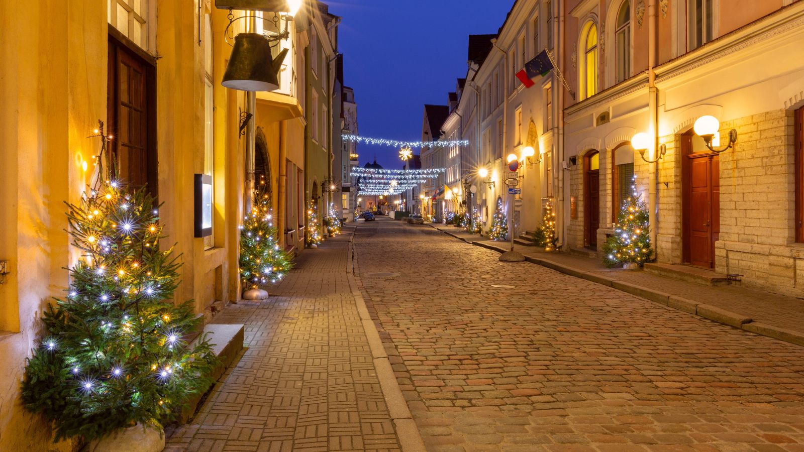 A photo of a peaceful European residential street at night with warm street lights and quiet atmosphere