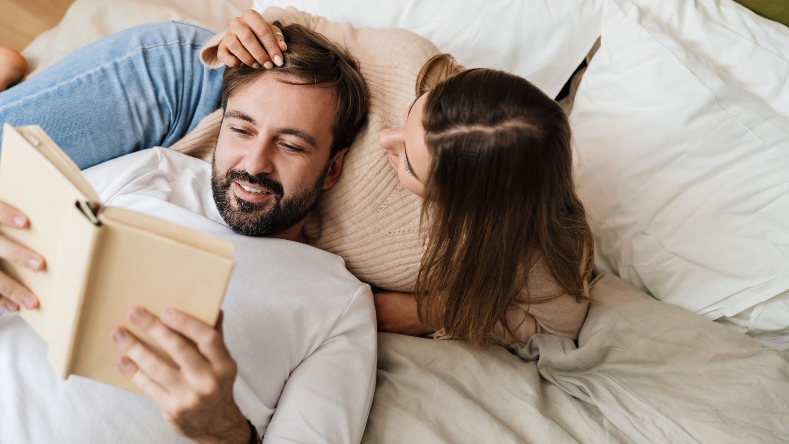 A photo of mature romantic couple relaxing together in hotel room peaceful intimate setting comfortable bed soft lighting calm travel experience natural light.