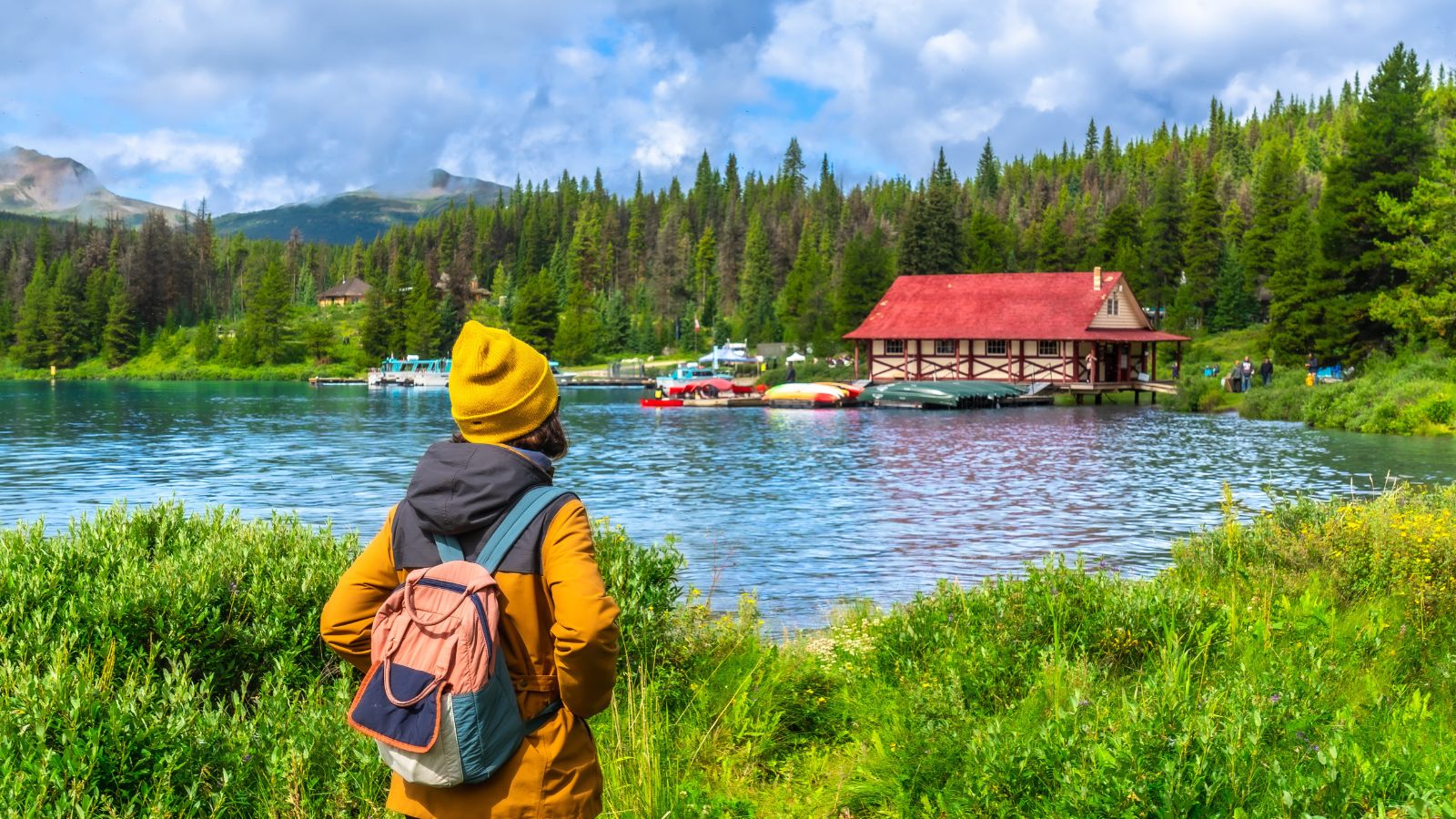 A photo of stunning Canadian mountain lake landscape with visitors enjoying nature, worth the travel cost.