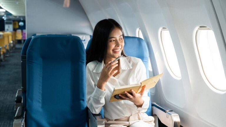 A photo of a woman sitting happily in her seat.