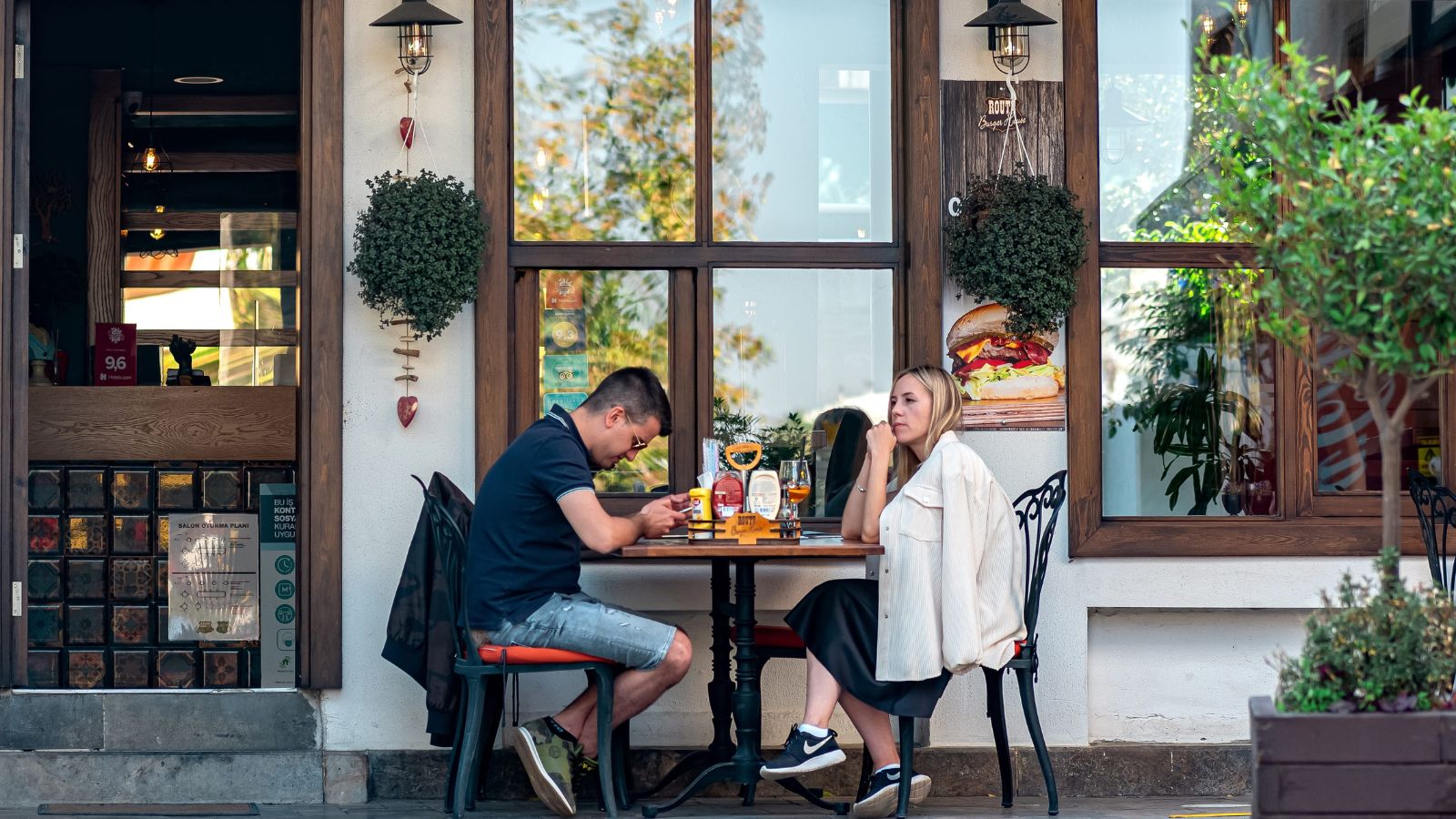 A photo of travelers enjoying a simple dinner at a small local restaurant near their hotel in a European city.