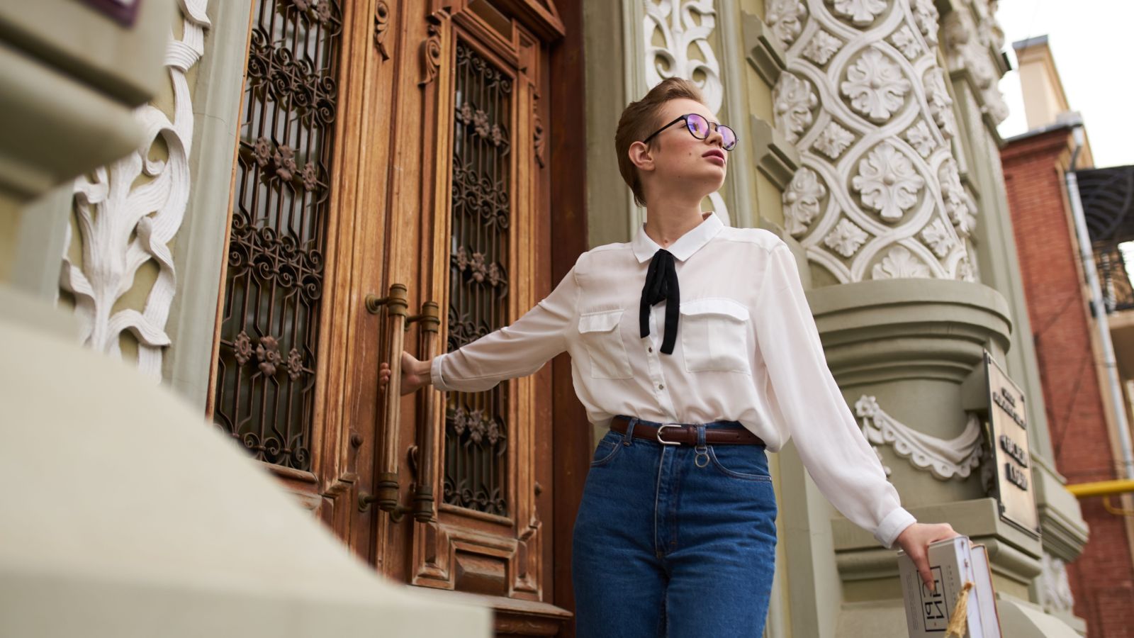 A photo of a woman entering a small botique.