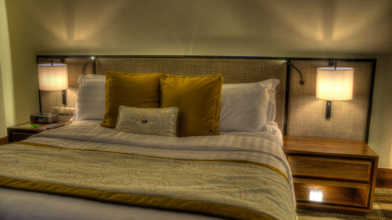 A photo of quiet hotel room interior comfortable bed soft lighting peaceful atmosphere away from noise restful travel stay.