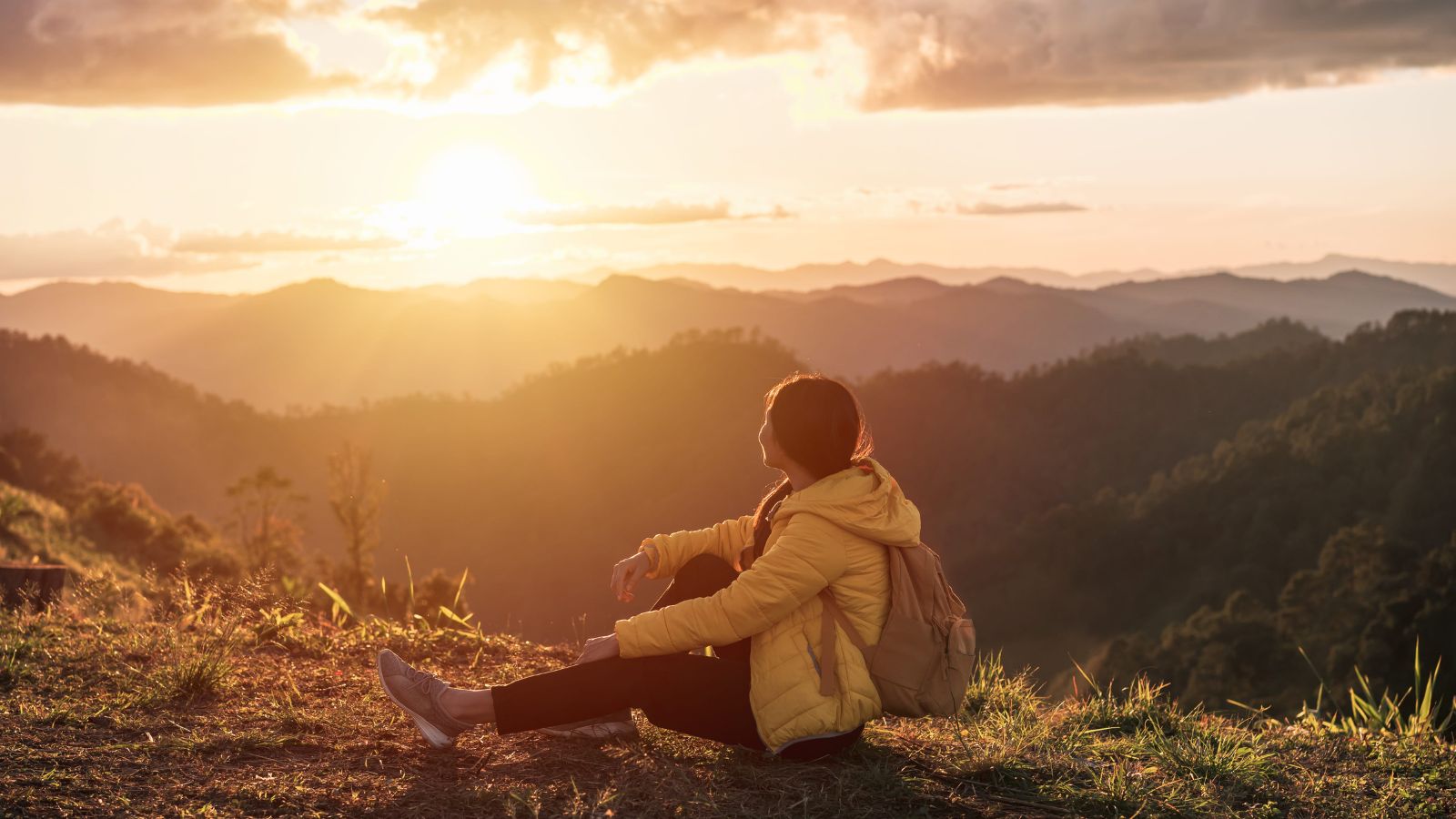 A photo of a “traveler enjoying scenic view or sunset calm peaceful travel experience reflective moment minimal schedule natural light.