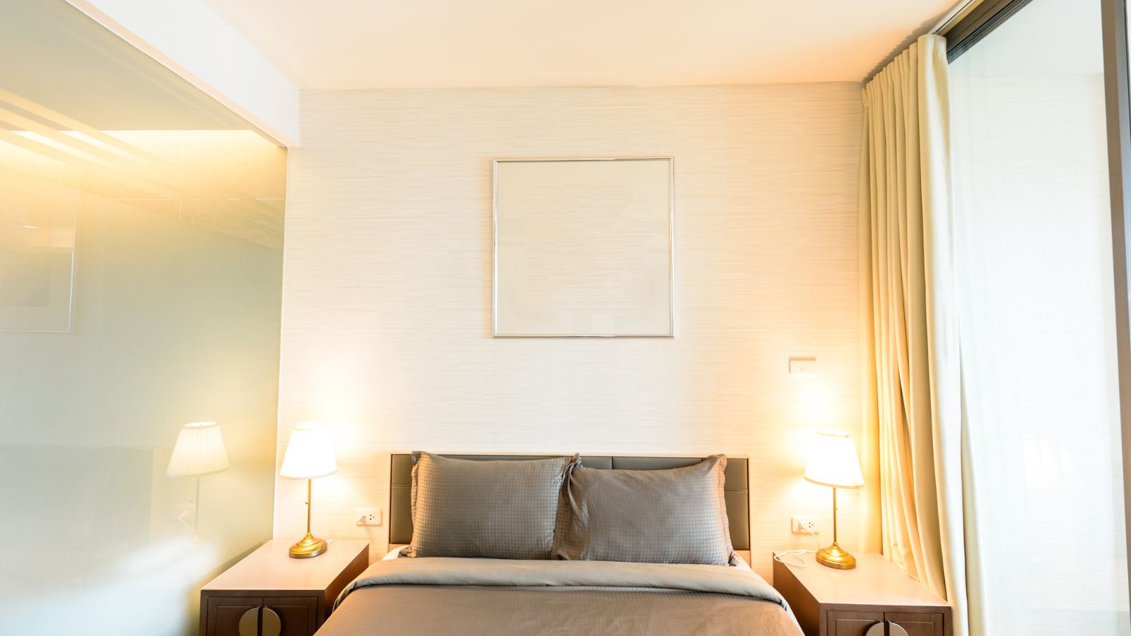 A photo of quiet well positioned standard hotel room soft lighting restful bed peaceful atmosphere.