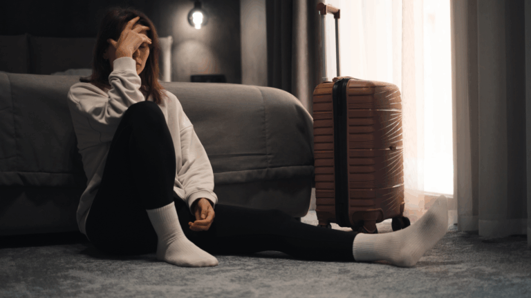 A photo of a tired traveler early morning rushing or late night exhausted in city or hotel travel fatigue long day candid realistic.