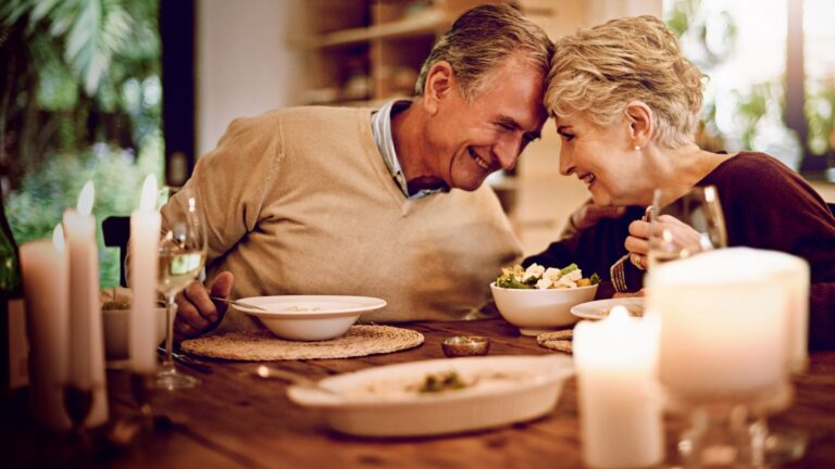 A photo of mature couple enjoying quiet dinner or scenic walk relaxed romantic travel slow pace quality experience natural light candid.