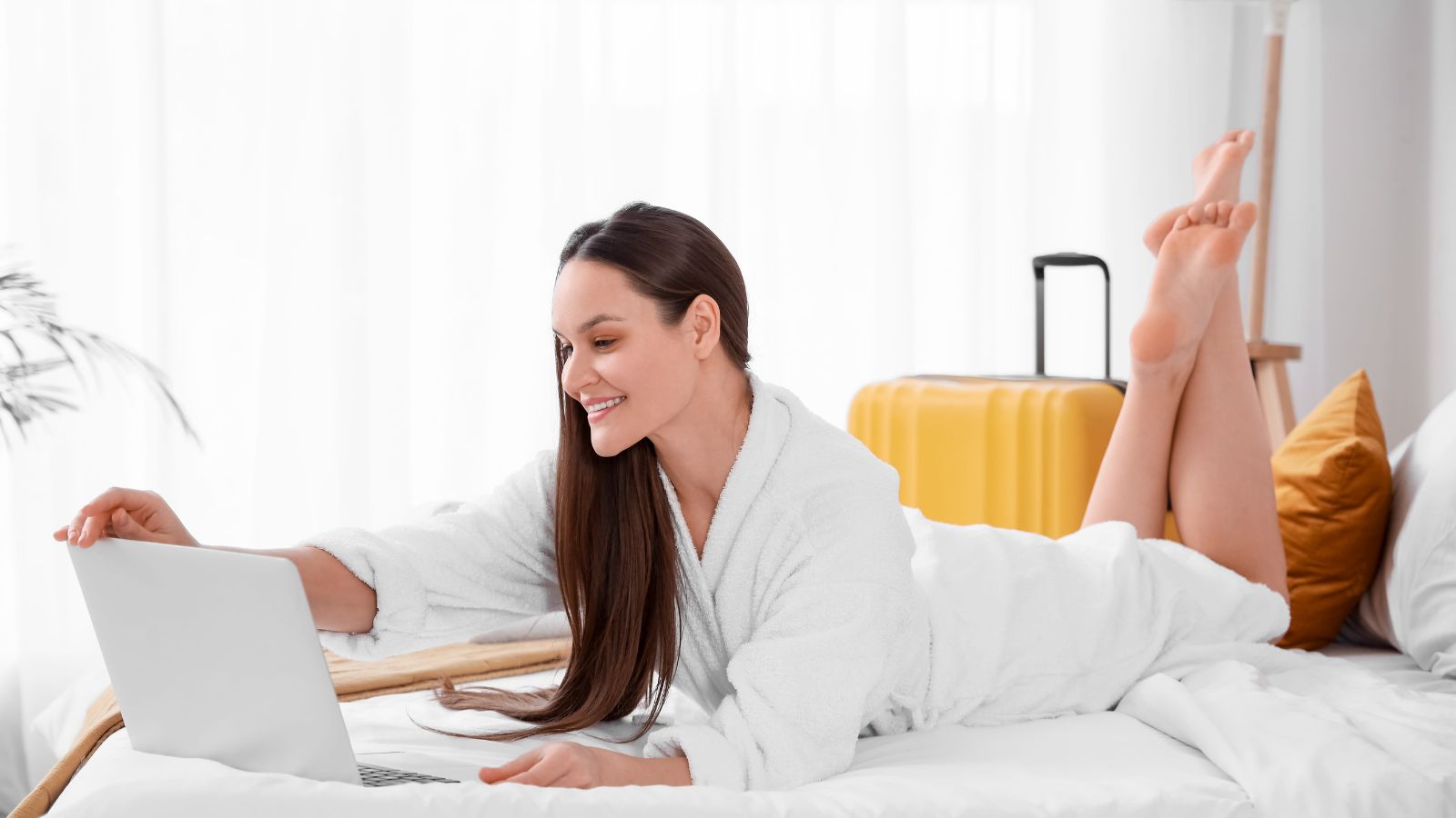 A photo of a happy hotel guest relaxed in room comfortable stay positive travel experience natural light candid.