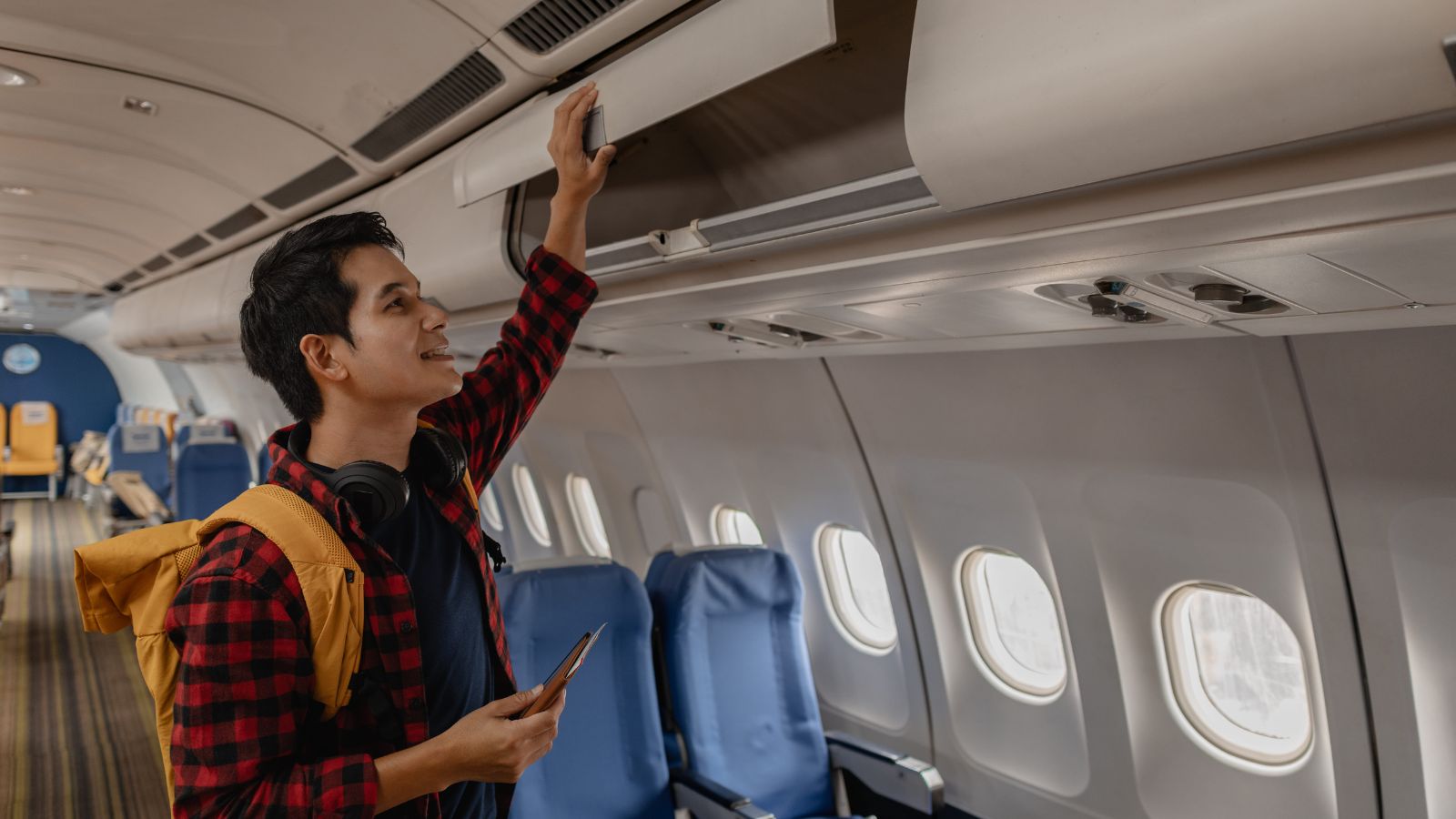 A photo of a traveler boarding airplane calmly without rush relaxed movement aisle minimal stress travel candid natural light.