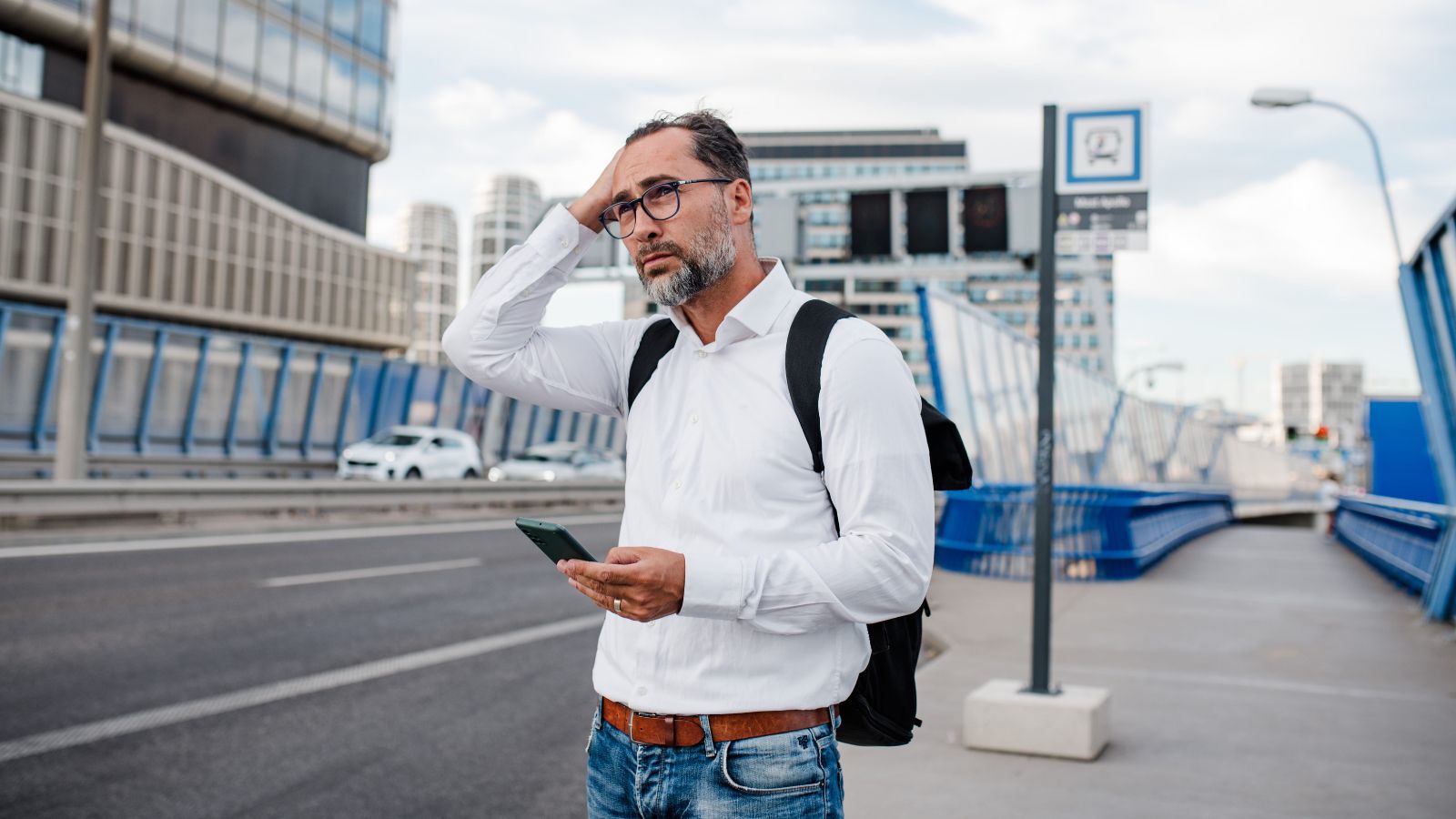A photo of a solo traveler walking briskly through busy airport or city street looking slightly tired and rushed mid-journey realistic travel moment natural light candid.