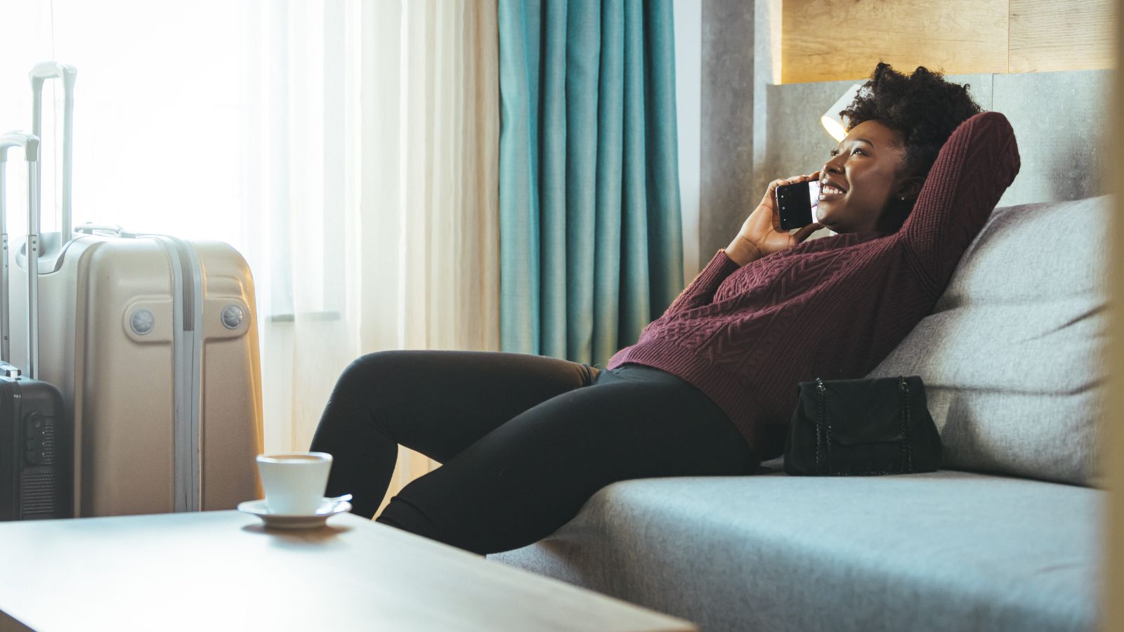 A photo of a traveler relaxing comfortably in a cozy hotel room, feeling satisfied with the hotel choice