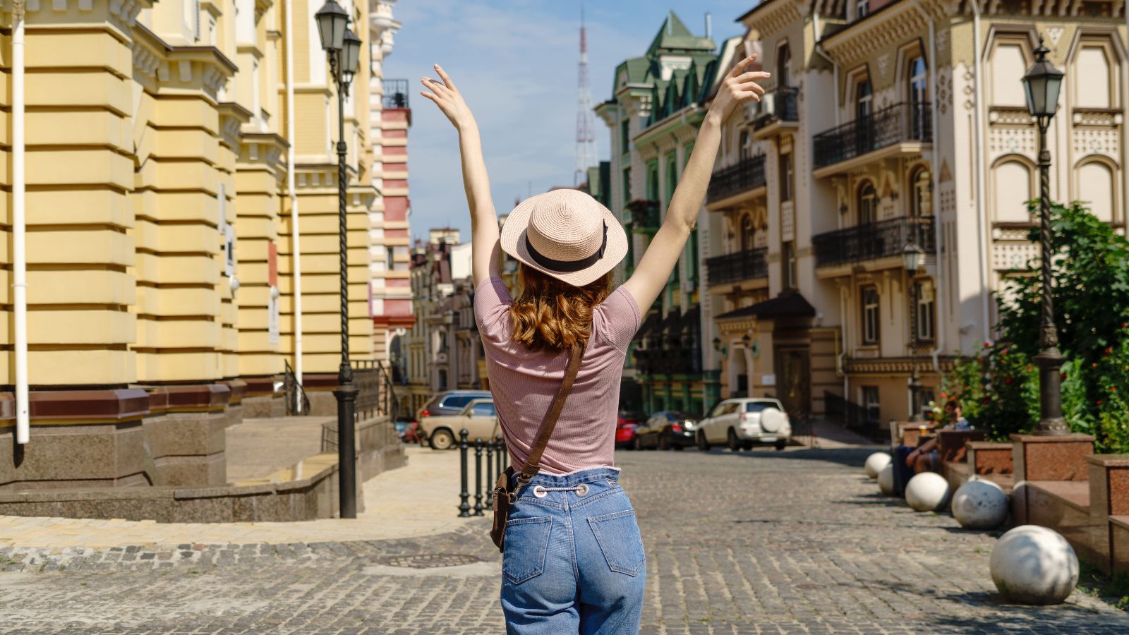 A photo of a traveler walking through a beautiful historic city street feeling relaxed and energized while exploring.