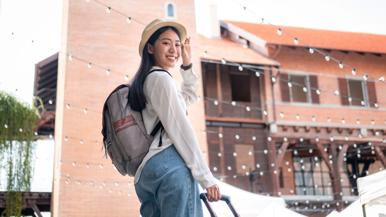 A photo of a relaxed traveler walking freely with small carry on enjoying trip light travel lifestyle natural candid.