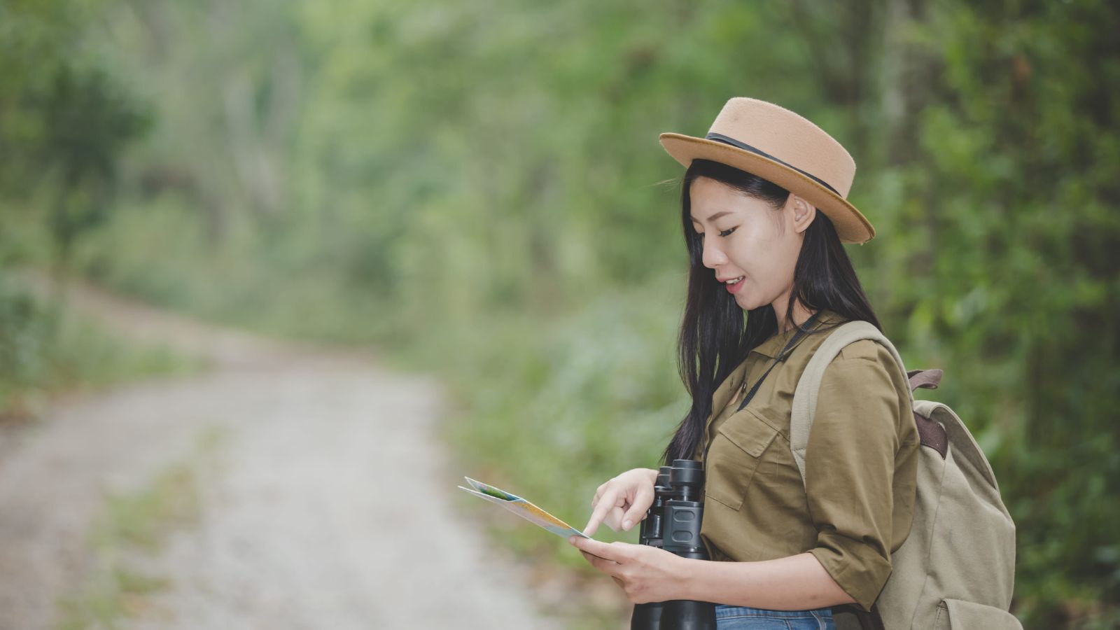 A photo of a traveler looking at travel itinerary or map with calm relaxed setting planning trip natural light flat lay.
