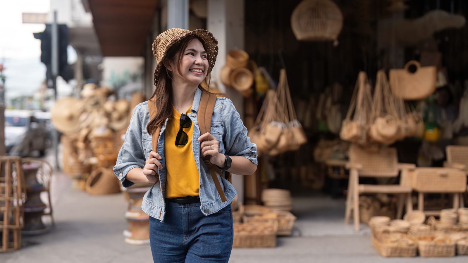 A photo of a traveler happily wandering through a lively street with local shops and music, enjoying an unplanned discovery.