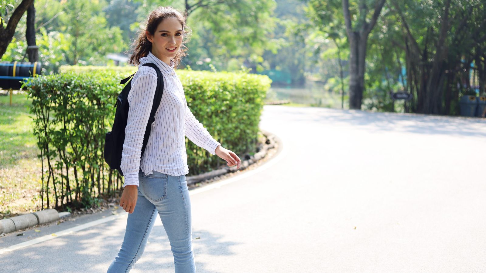 A photo of traveler walking through scenic city street relaxed content natural lighting urban travel candid authentic moment.