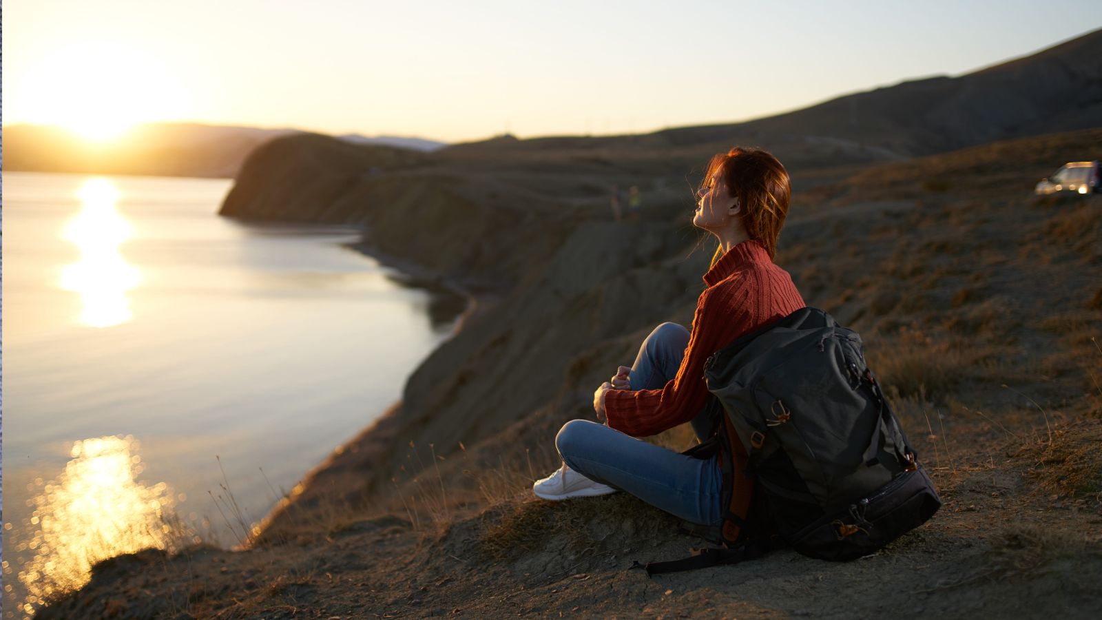 A photo of a traveler enjoying simple travel moment smiling relaxed accepting experience calm atmosphere.