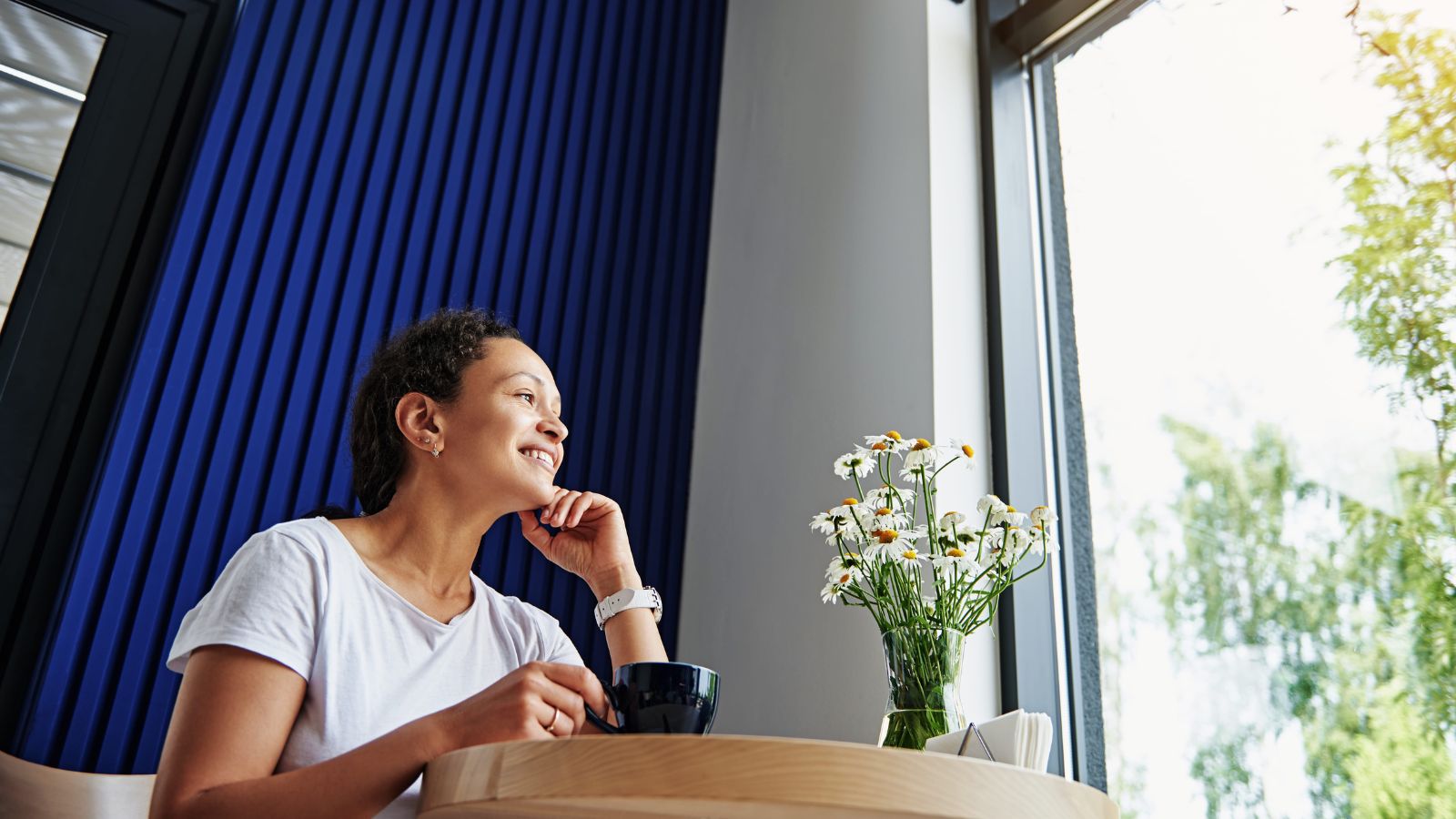 A photo of a relaxed traveler enjoying scenic view or cafe slow travel lifestyle peaceful no rush natural light candid.