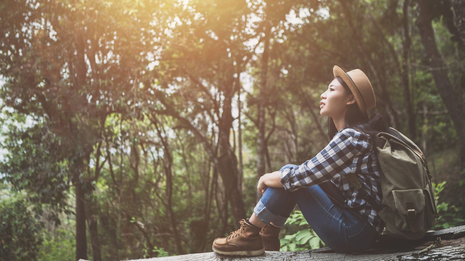 A photo of a solo traveler sitting peacefully enjoying surroundings calm adaptable travel experience relaxed present moment.