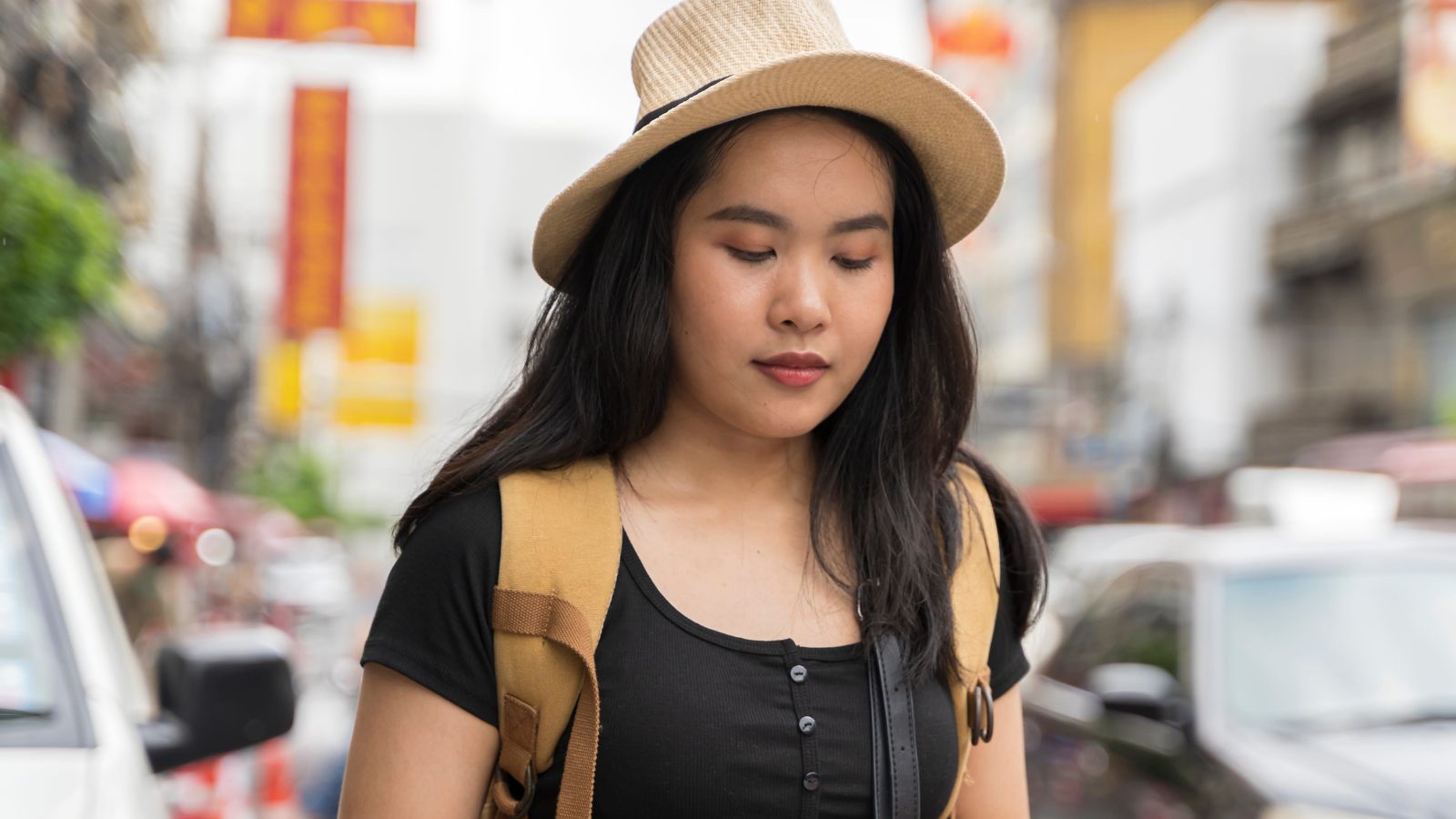 A photo of a solo traveler checking full travel itinerary on phone or notebook looking slightly stressed.