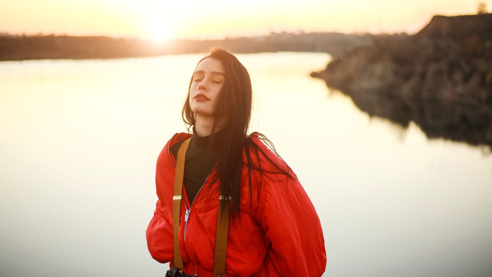 A photo of a traveler sitting peacefully in evening relaxed balanced mood calm travel day soft lighting cozy atmosphere.