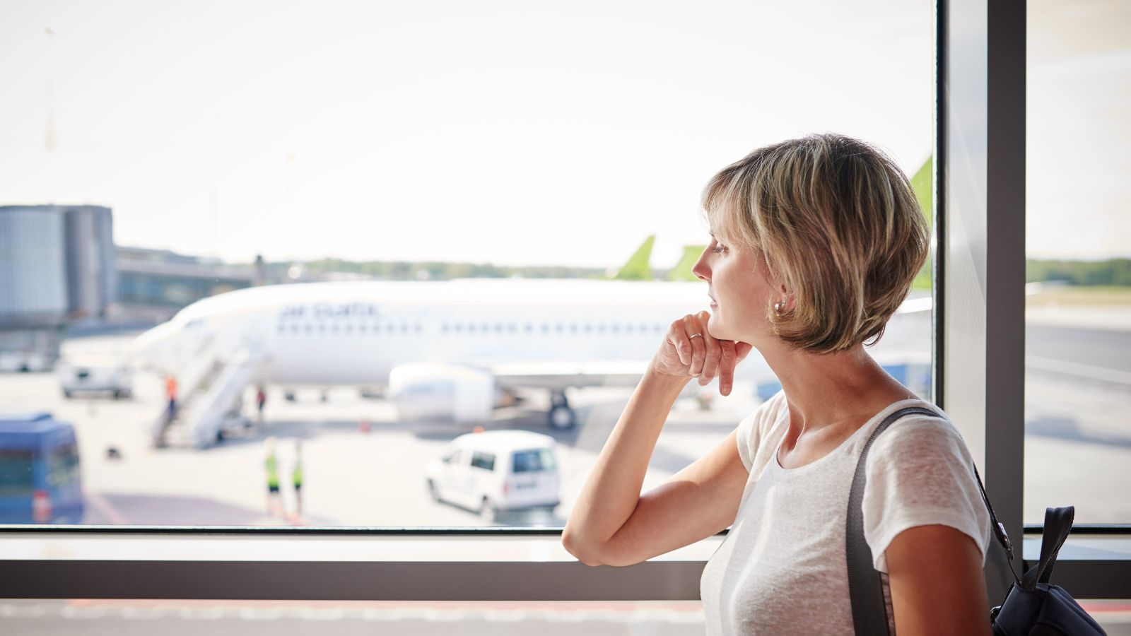 A photo of a woman looking at the plane.