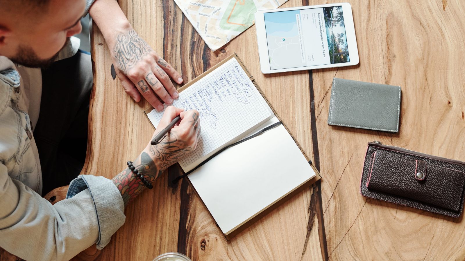 A photo of a traveler planning trip with map and phone showing multiple destinations focused but slightly overwhelmed travel.