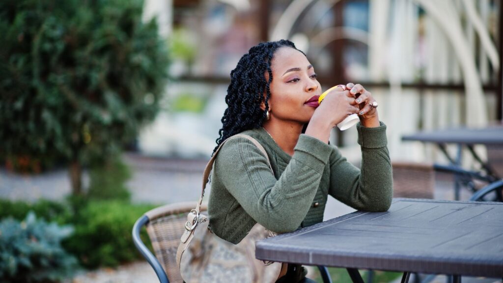 A photo of a traveler sitting at street cafe or strolling scenic street relaxed slow travel lifestyle spontaneous moment candid.