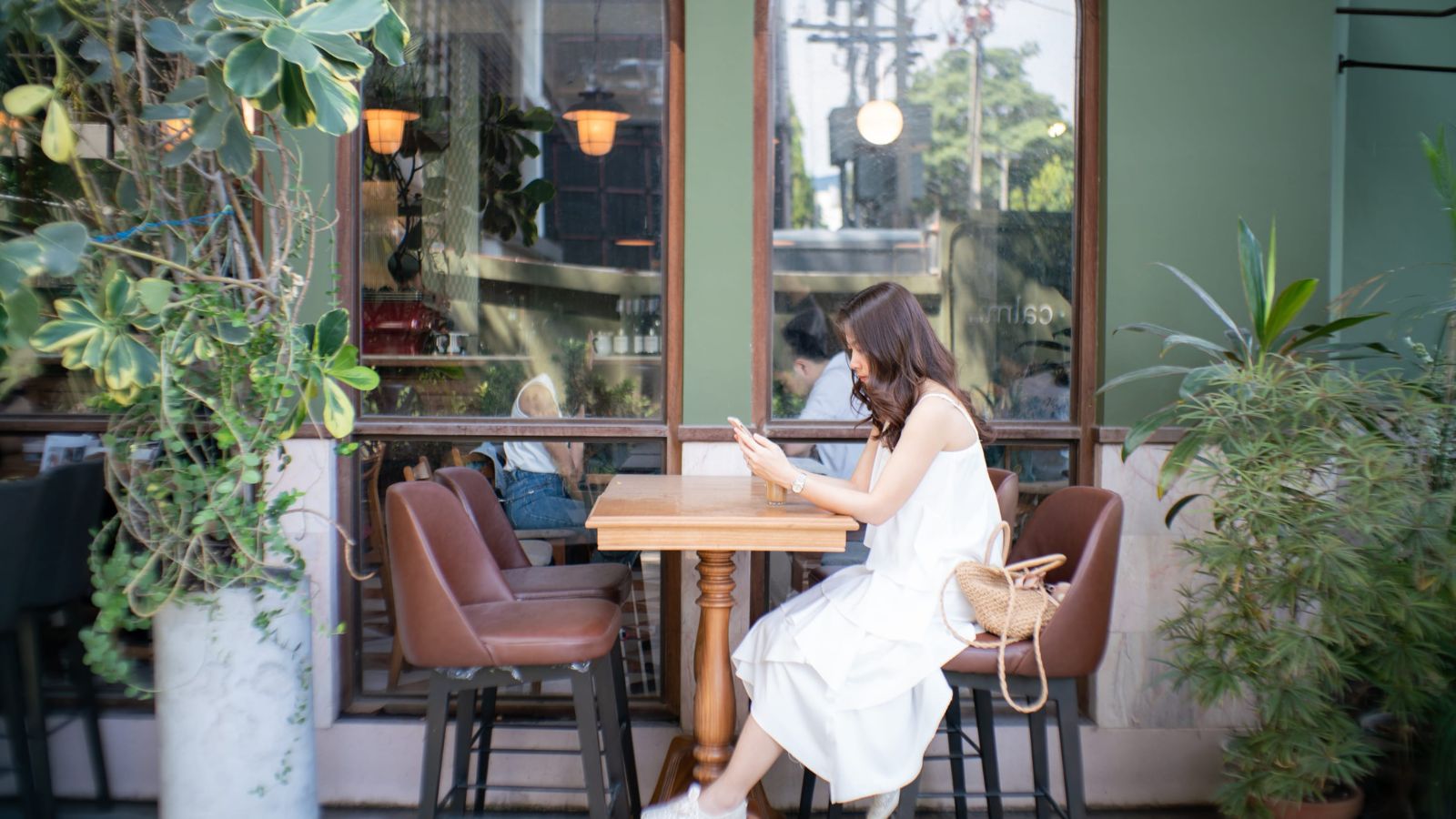 A photo of a traveler enjoying relaxed moment in one destination cafe or scenic street slow travel lifestyle peaceful no rush natural light.