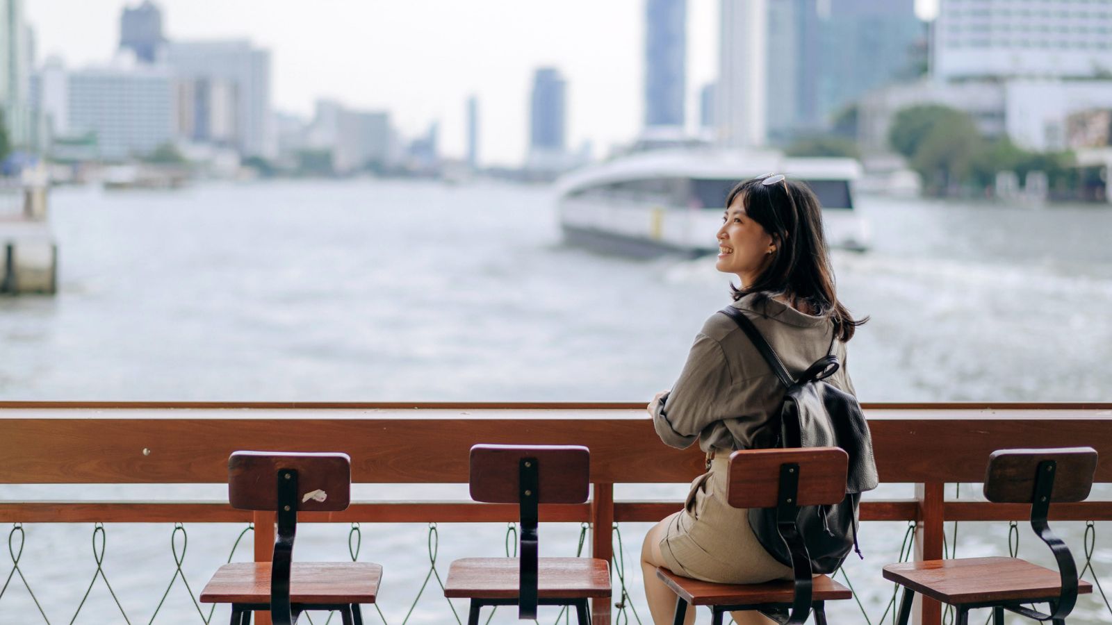 A photo of a Traveler pausing at a scenic holiday destination, calm and reflective mood, light colors, emphasizes intentional travel over hectic schedules.