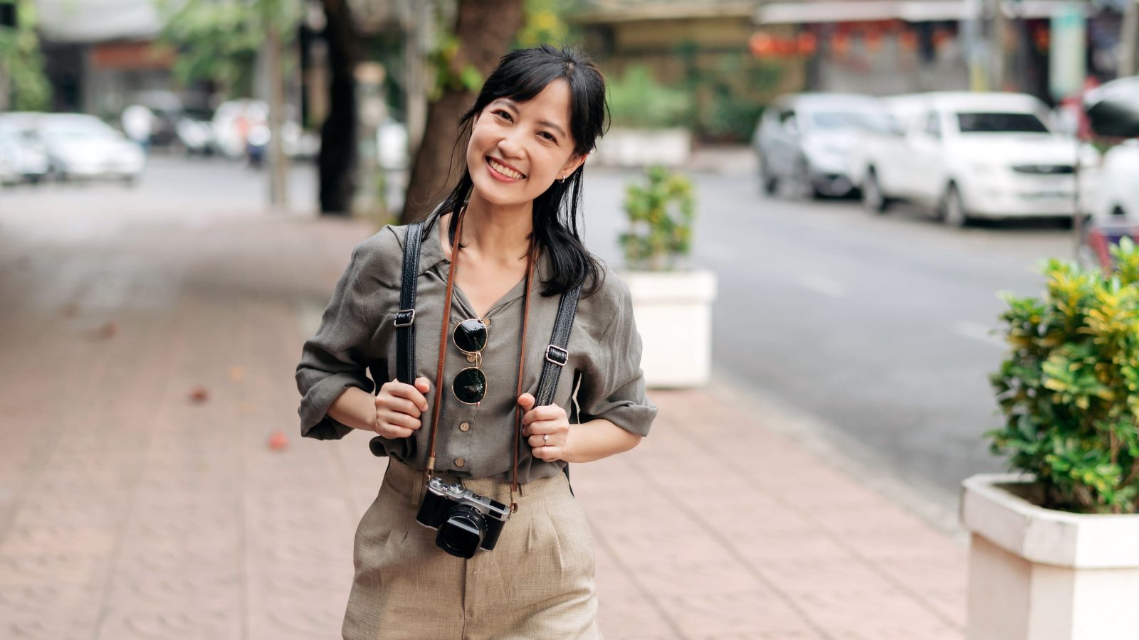 A photo of a traveler walking leisurely along scenic path or quiet city street smiling relaxed balanced travel experience calm natural light candid.