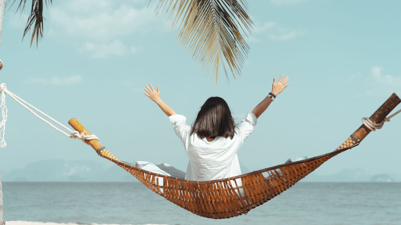 A photo of a woman enjoying the ocean view.