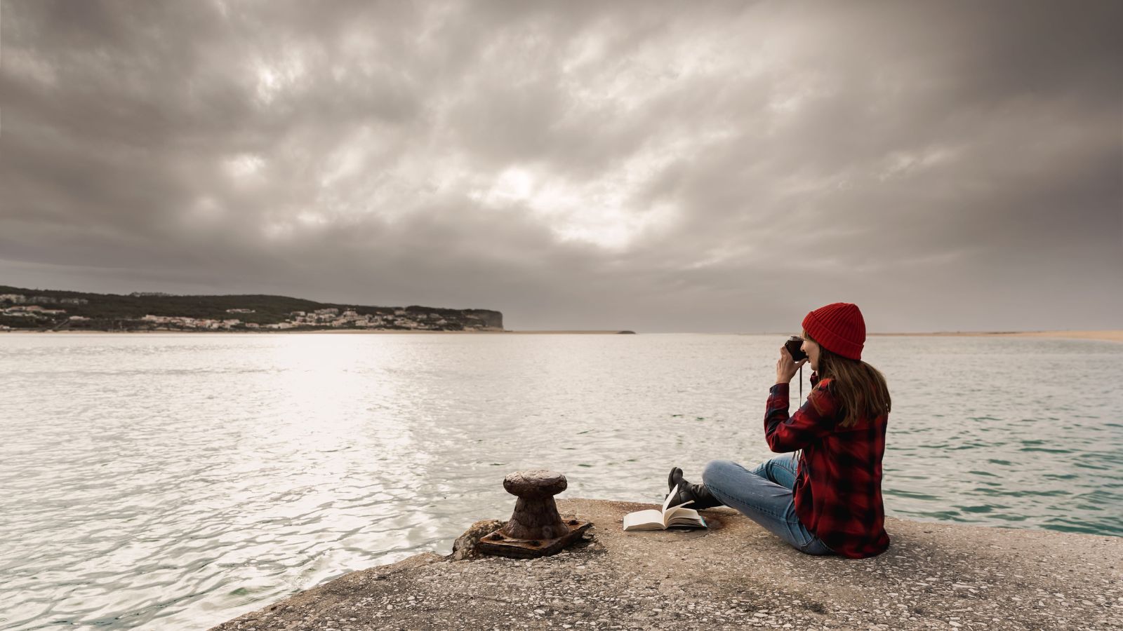 A photo of a traveler setting phone aside enjoying surroundings looking calm mindful present-focused travel moment.