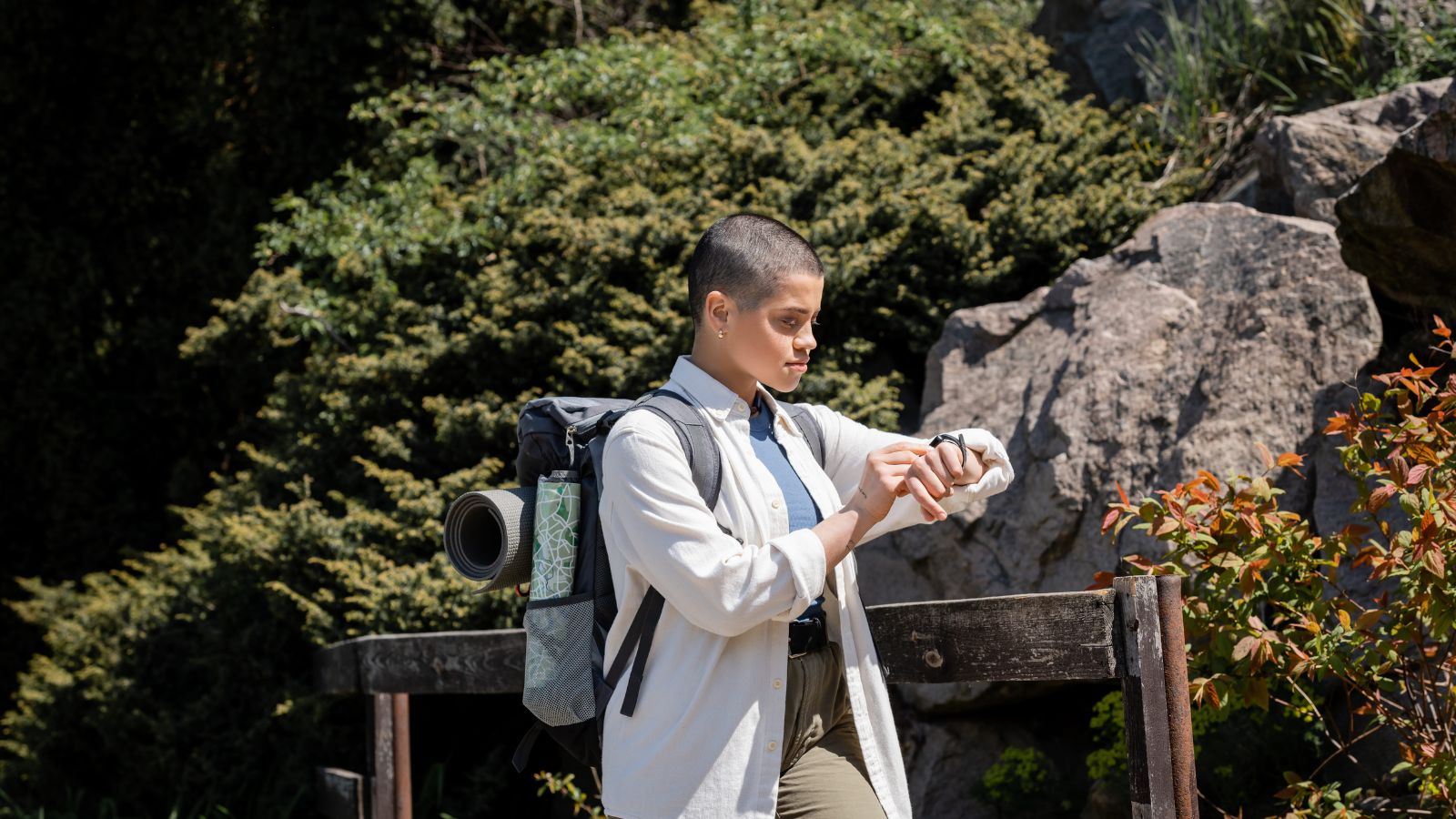 A photo of a “tourist in scenic location looking at phone or watch instead of surroundings distracted travel moment missed experience candid.